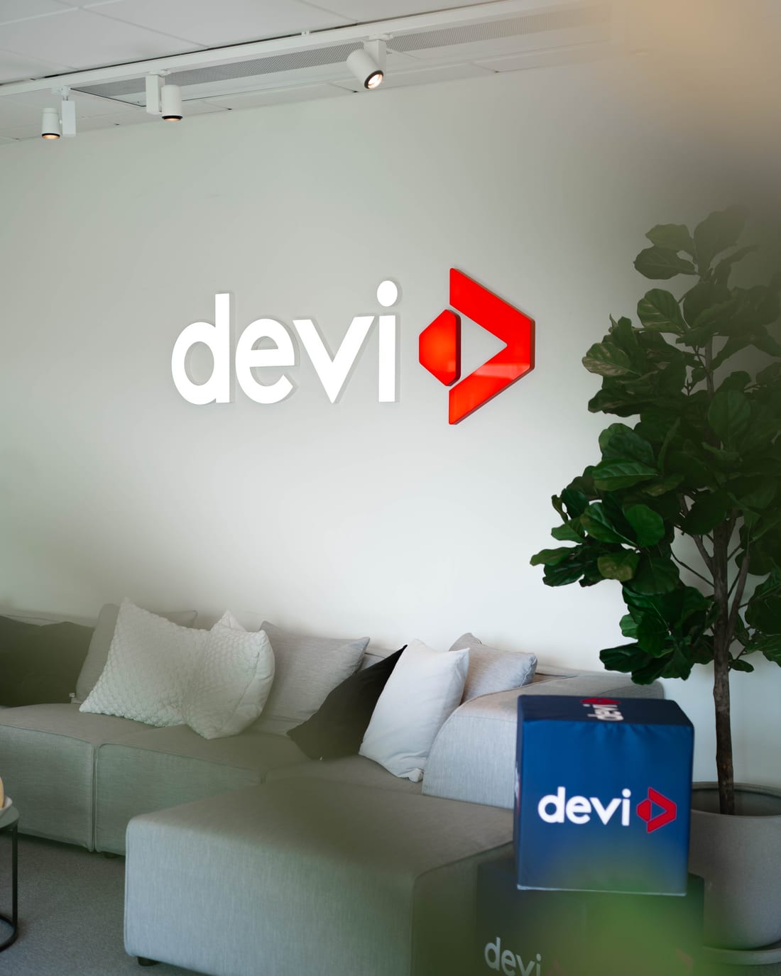 Devi Group's office with the Devi logo on the wall